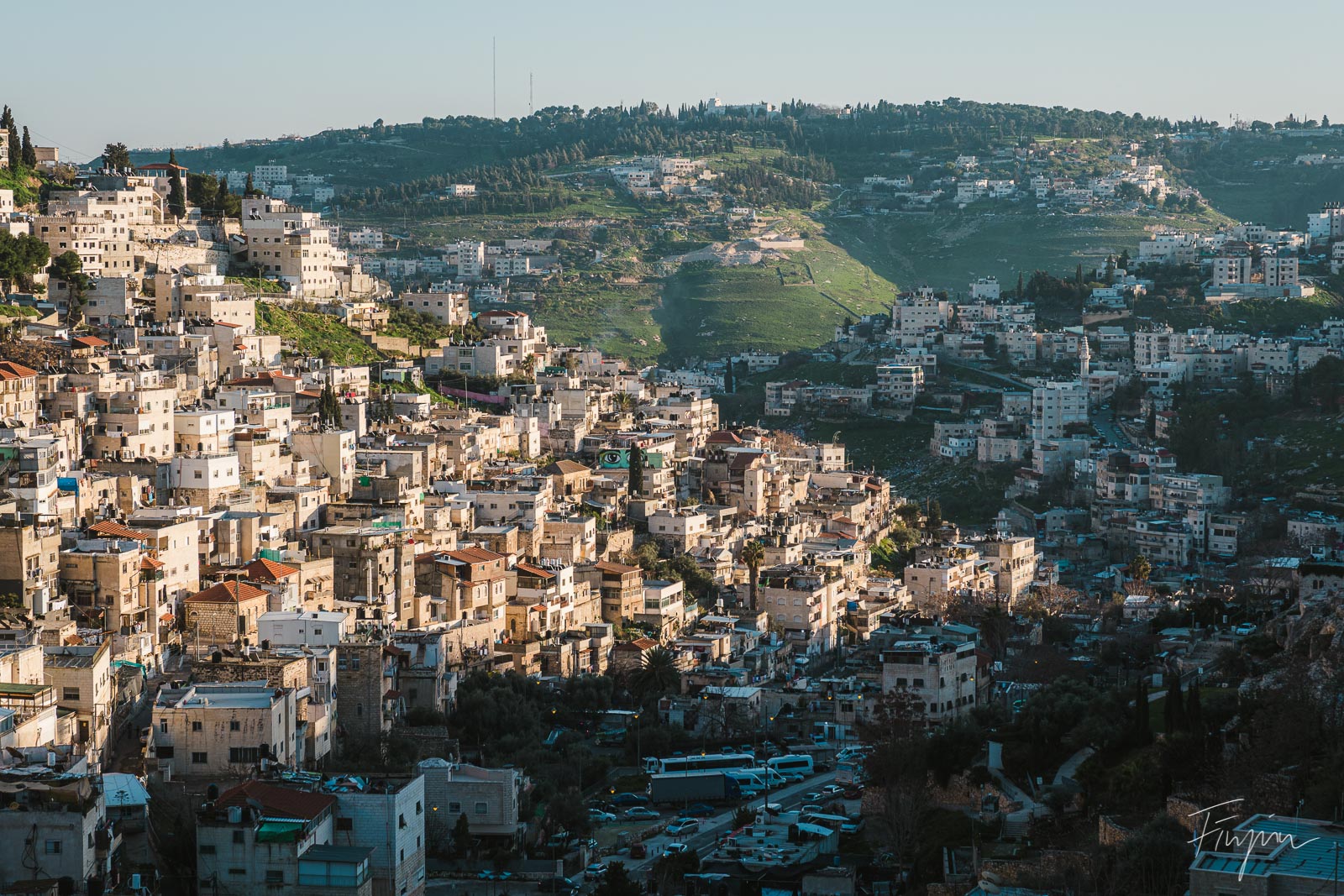 Sund and shade divide houses in a valley in Jerusalem